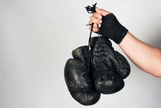 Man Holding Black Boxing Gloves