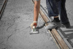 Construction workers leveling concrete pavement