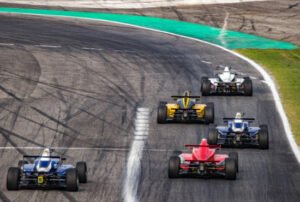 Men driving formula racing cars